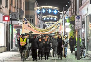 Der liturgische Lichtermarsch zog auch durch die Marktstraße. Rund 100 Bürger nahmen daran teil und sangen für den Frieden.   Foto: Baublies