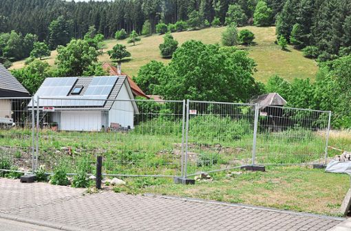 In der Dorfstraße steht bereits der Bauzaun: Hier soll gegenüber der Kirche ein Mehrfamilienhaus entstehen. Foto: Lübke