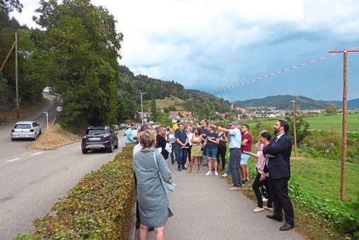 Planer Roland Gäßler (mit Mütze) erläutert die Probleme der Herrenberg-Trasse im Einmündungsbereich Gemsbühl. Die Holzstangen markieren die Fahrbahnhöhe der geplanten Straße. Foto: Dorn